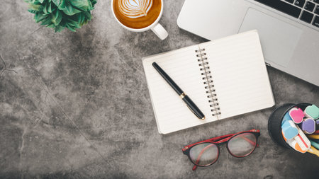 Office desk workplace with laptop, pen, notebook, eyeglass and cup of coffee, Top view flat lay with copy space.の写真素材