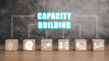 Capacity building concept, Wooden block on desk with capacity building icon on virtual screen.の写真素材