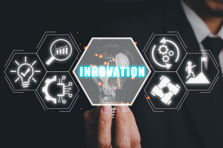 Innovation concept, Businessman hand holding light bulb with innovation icon on virtual screen.の写真素材
