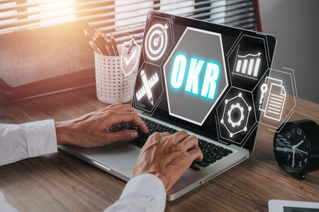 OKR, Objectives and Key Results concept, Business person working on laptop with Objectives and Key Results icon on virtual screen, Methods for project management.の写真素材