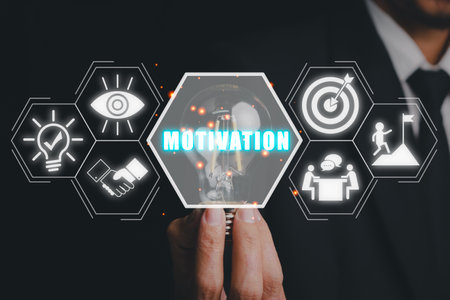 Motivation concept, Businessman hand holding light bulb with motivation icon on virtual screen.の写真素材