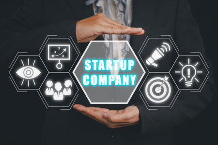 Startup company concept, Businesswoman hand holding start up company icon on virtual screen.の写真素材