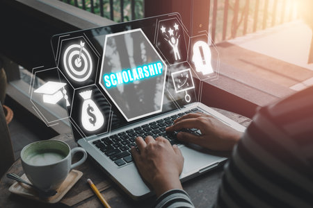 Scholarship concept, Person worjing on laptop computer with scholarship icon on virtual screen.の写真素材