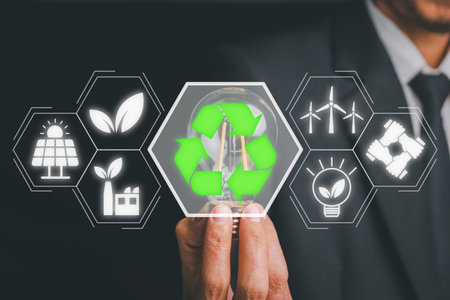 Businesswoman hand holding light bulb with esg icon on virtual screen, ESG Environmental, social and corporate governance concept.の写真素材
