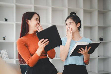 Business woman talking to her colleague during a meeting in a boardroom, Business team working on digital tablet.の写真素材