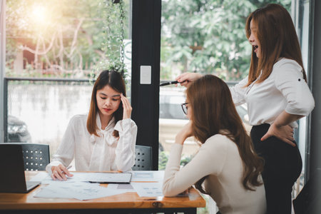 Serious business team leader coach mentor talk to diverse business people in office explain strategy at corporate group meeting, multiethnic staff listen to boss instruct interns at briefingの写真素材