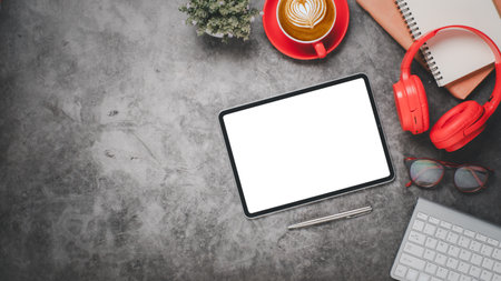 Office desk workplace with blank screen digital tablet for product display, keyboard, pen, eyeglass, notebook and cup of coffee, Top view flat lay with copy space.の写真素材