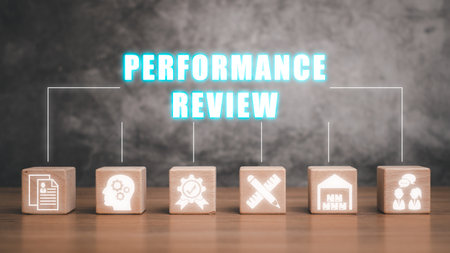 Performance review concept, Wooden block on desk with performance review icon on virtual screen.の写真素材