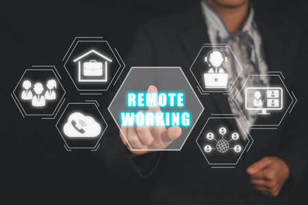 Remote working concept, Business person hand touching remote working icon on virtual screen.の写真素材