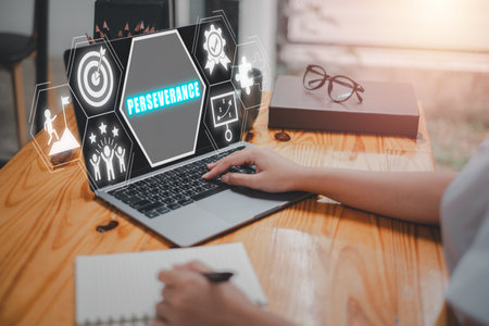Perseverance concept, Business person using laptop computer on desk with perseverance icon on virtual screen. Planning, Focus on Target, Confidence, Patience, Endurance, Determination, Ambition.の写真素材