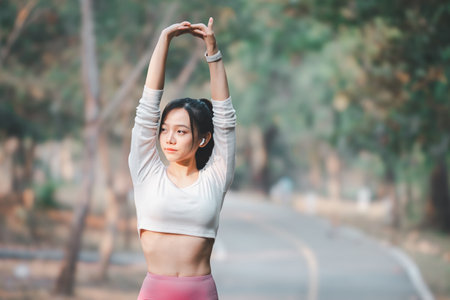 Fitness concept, Fit young woman doing a stretching routine in a park, staying healthy with outdoor exercise.の写真素材