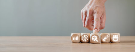 Value chain concept, Hand holding wooden block on desk with value chain icon on virtual screen.