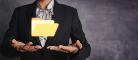 Folder concept, Businesswoman hand hold folder icon. Document Management System or DMS setup by IT consultant with modern computer are searching managing information and corporateの写真素材