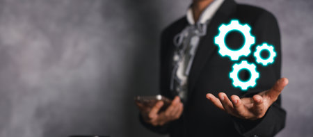 Metal gears concept, Businesswoman hand holding Metal gears metal gears and cogwheels mechanism representing interaction teamwork conceptの写真素材