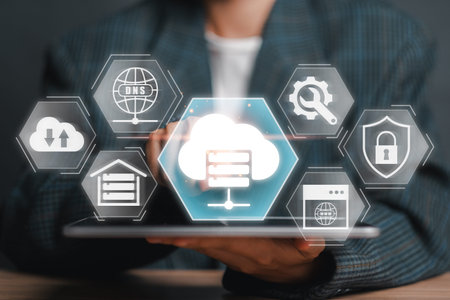 A person holding a tablet displaying cloud computing, network security, and hosting icons,...