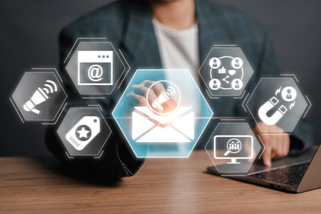 A businessman interacts with digital icons representing e-mail marketing concepts, showcasing modern online marketing strategies.の写真素材