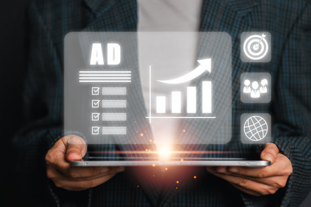 Businessman holding a tablet with digital marketing icons, graphs, and analytics representing growth and strategy.の写真素材