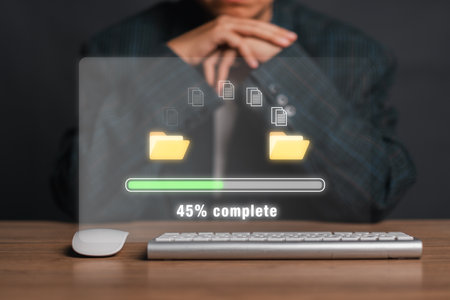 A digital file transfer concept showing progress with folders and documents on a virtual screen, indicating 45% completion.の写真素材