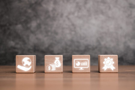 Wooden blocks displaying financial icons representing the concept of International Financial...
