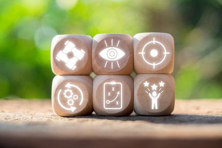 Wooden blocks with futuristic icons symbolize innovation and advancement in a natural setting.の写真素材