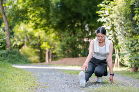 Woman stretching in a park, promoting fitness and wellness in a natural outdoor setting.