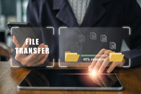 Visual representation of digital file transfer using smartphone and tablet, highlighting modern data exchange technology.の写真素材
