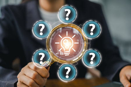 A business professional uses a magnifying glass to explore ideas, symbolizing critical thinking and problem-solving.の写真素材