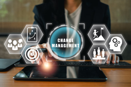 Visual representation of change management with digital icons and a professional using a tablet, symbolizing strategy and innovation.の写真素材