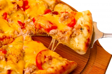 Appetizing pizza cheese on wooden tray closeup on white background (clipping path)の写真素材