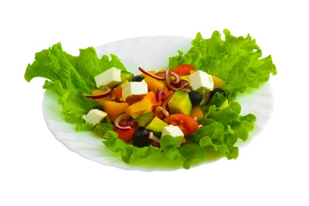 Fresh salad with tomatoes, cucumbers and peppers with cheese and herbs on a white background (clipping path)の写真素材