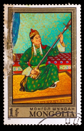 MONGOLIA - CIRCA 1972: A stamp printed by MONGOLIA , girl playing on a stringed musical instrument, circa 1972のeditorial素材