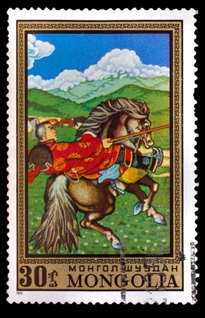 MONGOLIA - CIRCA 1972: A stamp printed by MONGOLIA , rider in national dress, riding a black horse, circa 1972のeditorial素材