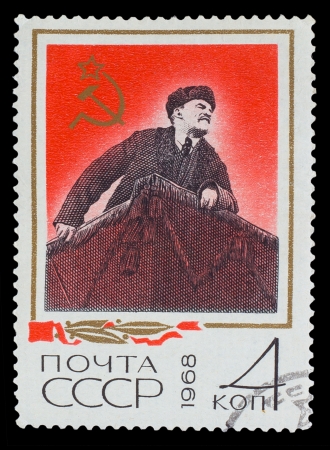 USSR - CIRCA 1968: A Stamp printed in USSR, shows Vladimir Ilyich Lenin in his hat with earflaps stands on podium, circa 1968のeditorial素材