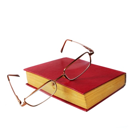 glasses and a red book isolated on white backgroundの写真素材