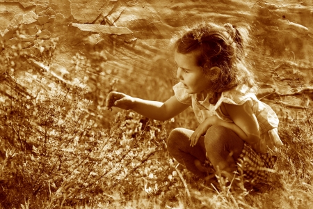 retro sepia photo, little baby girl studying touching look yelloの写真素材