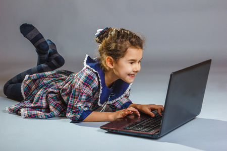 baby girl looking computer and smilingの写真素材