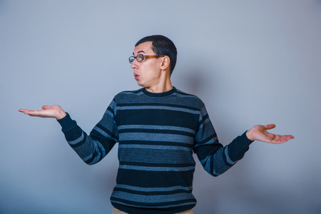 European -looking man  years with glasses, does  not  knowの写真素材