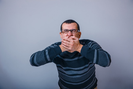 European-looking man of 30 years with  glasses, closed  his moutの写真素材
