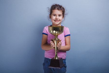 girl child 6 years of European appearance holds a cupの写真素材