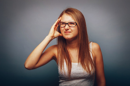 European appearance blonde girl with glasses put a hand to his hの写真素材