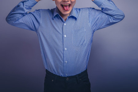teenager boy brown hair of European appearance grimaces experien