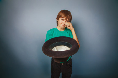 European-looking boy of ten years beggar, poor, asks for money oの写真素材