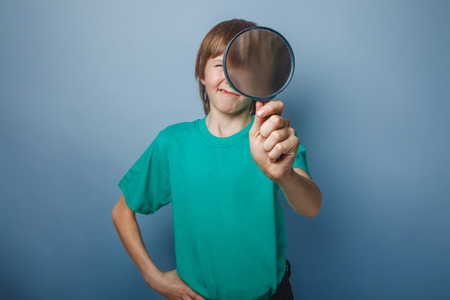 teenager boy brown European appearance in a green T-shirtの写真素材