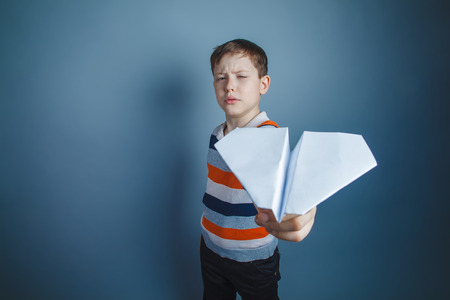 boy teenager European appearance Brown launches a paper airplaneの写真素材