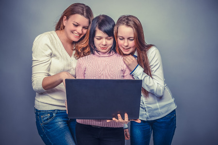 Three girls European  appearance  girlfriend looking at computerの写真素材