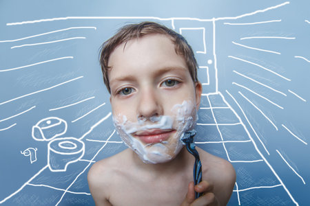 the boy of the European appearance decade person shaves, shaving foam on gray  backgroundの写真素材