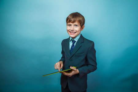teenager boy dressed businessman holding  tablet Photo Studio