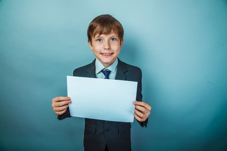 Teen boy signboard businessman holding a sign on the background of the photo studioの写真素材
