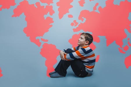 boy teenager European appearance Brown turned his back on a black backgroundの写真素材