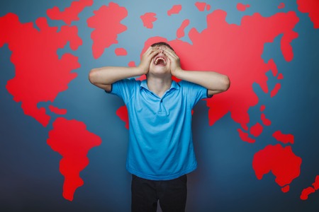 boy teenager European appearance Brown turned his back on a black backgroundの写真素材